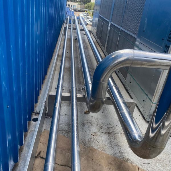 Installation and cladding of stainless steel piping for pre-formed plant.